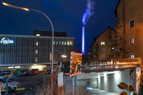 Glowing blue chimney from the CHP plant in the evening, Erlangen.Mittelfranken, Bavaria, Germany