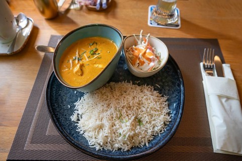 Indian dish: chicken breast pieces in curry sauce with rice and salad, Franconia, Bavaria, Germany