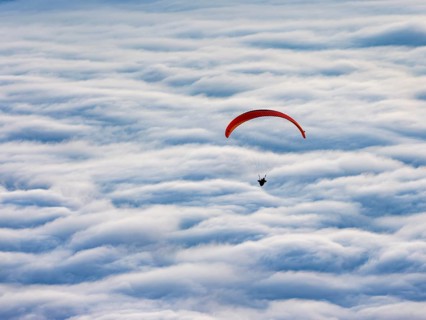 Paragliding flying over a sea of fog, Gaisberg, Salzburg, Salzburger Land, Austria
