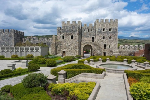 Historical complex with massive stone fortress, well-kept garden and round fountain, Rabati