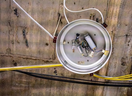 Old neon tube ceiling lamp hanging on a bare concrete ceiling, Berlin, Germany
