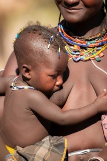 Woman, with baby tribe of Hakaona, also Havakona or Hakawona, near Opuwo, Kunene, Namibia