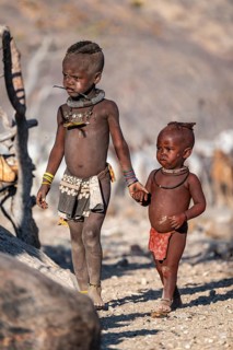 Himba children shake hands, traditional Himba village, Kaokoveld, Kunene, Namibia