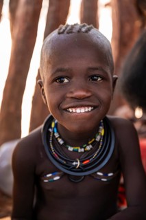 Portrait, grinning Himba child, traditional Himba village, Kaokoveld, Kunene, Namibia