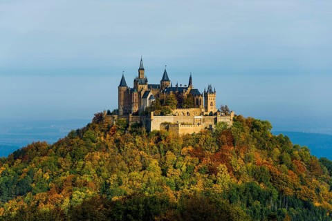 Castle and autumnal forest, Hohenzollern Castle, sunrise, Hechingen, Swabian Jura,