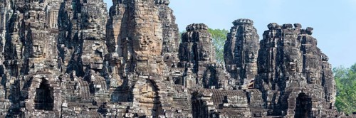 Panoramic picture of huge stone-carved faces of Bodhisattva Lokeshvara, also Avalokiteshvara, Bayon