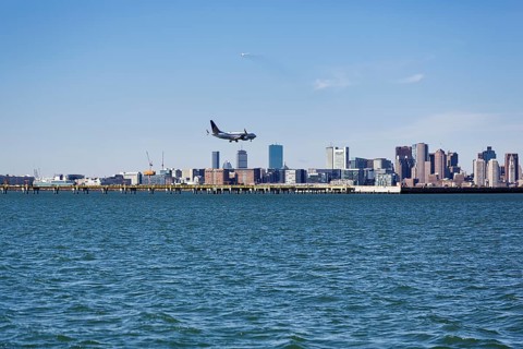 Boston skyline with an airplane landing at Logan International Airport, Boston, Massachusetts, New