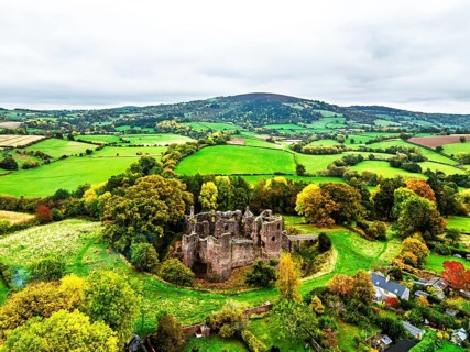 Autumn Colours over ruins of Grosmont Castle from a drone, Grosmont, Monmouthshire, Wales, UK
