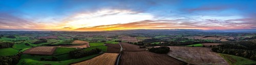 Sunset of Devon Farms and Fields over Berry Pomeroy from a drone, Totnes, England, United Kingdom