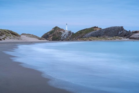 Deliverance Cove and Castlepoint Lighthouse on the rock, ocean, long exposure, evening.
