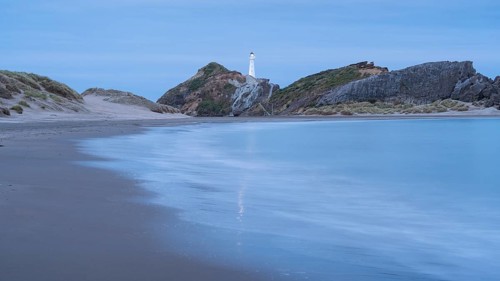 Deliverance Cove and Castlepoint Lighthouse on the rock, ocean, long exposure, evening, illuminated