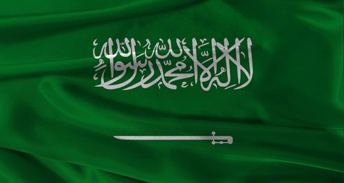 Flag of Saudi Arabia with fabric textured background. Close up of National flag of Saudi Arabia