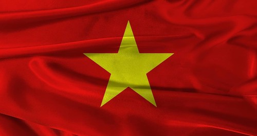 Flag of Vietnam with fabric textured background. Close up of National flag of Vietnam with
