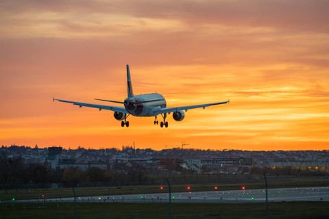 Airplane flying over illuminated runway at sunset, Stuttgart Airport, Leinfelden-Echterdingen,