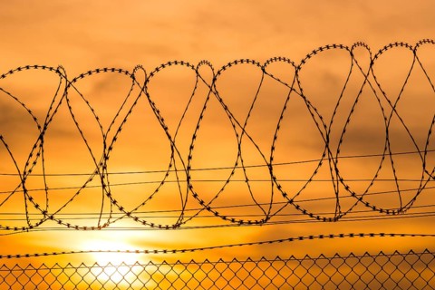 Barbed wire and sunset, warm colors fill the sky, Baden-Württemberg, Germany