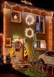 Christmassy kitschy illuminated façade of a row house in Gelsenkirchen-Ückendorf in the evening,