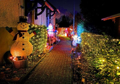 Christmassy kitschy illuminated entrance of a terraced house in Gelsenkirchen-Ückendorf in the