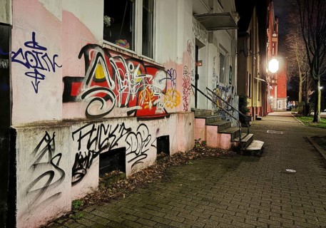 Facade covered with graffiti at night in a problem district, no-go area in Gelsenkirchen, one of