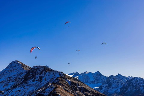 Paragliders fly over the mountains of the Valais Alps, Val d'Anniviers, Valais Alps, Canton of