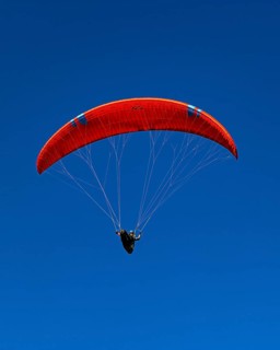 Paragliders against a blue sky, Val d'Anniviers, Valais Alps, Canton of Valais, Switzerland