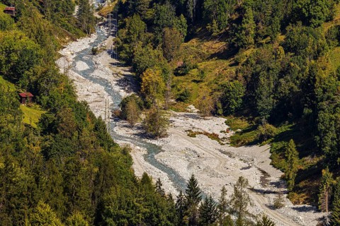 Power lines in the gravel bed of the Navisence stream, Val d'Anniviers, Valais Alps, Canton of