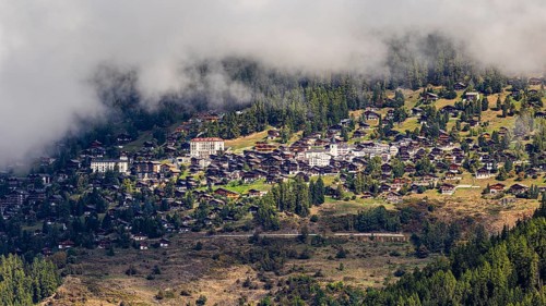 Fog is gathering over the mountain village of Saint-Luc, Val d'Anniviers, Valais Alps, Canton of