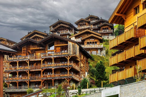 Dark clouds over wooden holiday homes, Grimentz, Val d'Anniviers, Valais Alps, Canton of Valais,