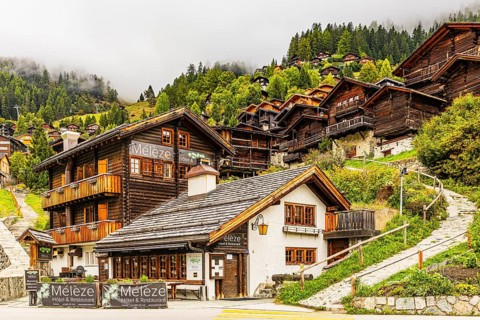 Hotel Restaurant Meleze in front of historic farmhouses, Grimentz, Val d'Anniviers, Valais Alps,