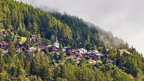 Rising fog over the mountain village of Saint-Luc, Val d'Anniviers, Valais Alps, Canton of Valais,