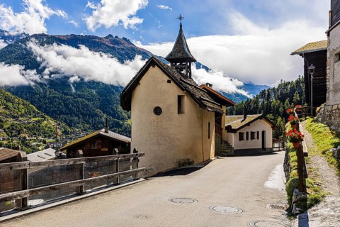 The chapel in Pinsec, fog rising behind in the Val d'Anniviers, Valais Alps, Canton of Valais,