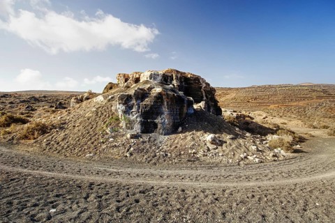 An abandoned quarry with rock formations under a sky with scattered clouds, Los Roferos (Stratified