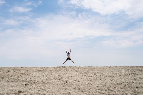 Abstract, man jumping on the Etosha pan, salt pan, Etosha National Park, Namibia