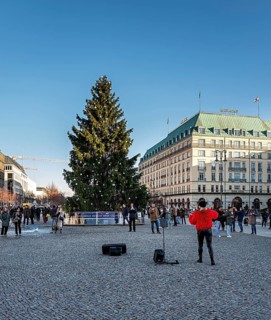 Street musician with violin at Brandenburg Gate, daylight photo, Berlin, Germany