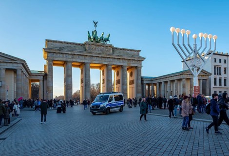 Large Hanukkah chandelier at the Brandenburg Gate in daylight, sign of lively Jewish life, symbolic