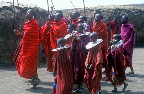 Maasai men and girls in their village in the Ngorongoro Crater dancing for tourists, Tanzania,