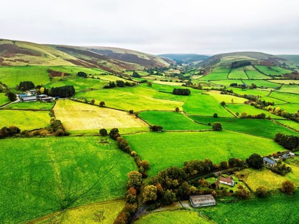 Autumn colours of Farms over River Wye and Road A470 from a drone, Llanidloes, Powys,
