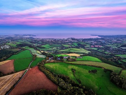 Sunset of Devon Farms and Fields over Berry Pomeroy from a drone, Totnes, England, United Kingdom