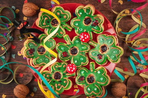 Shamrock shaped cookies with green icing and decoration for New Year