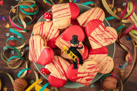 Heart-shaped cookies with red icing and decoration for New Year