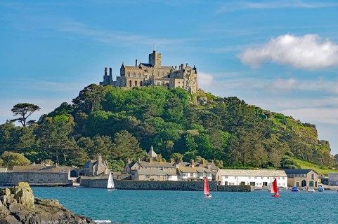 A majestic castle perched on a green hill in front of the sea, Penzance, Saint Michael's Mount,