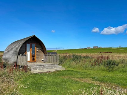 Small wooden house on a green field under clear blue sky on a sunny day, Pod, holiday