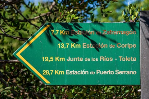 Signpost showing distances along cycle path Via Verde de la Sierra, Puerto Serrano to Olvera, old