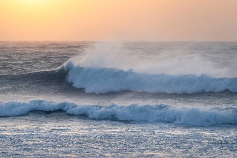 Ocean waves, strong surf, sunset, west coast of the Taranaki region, North Island, New Zealand
