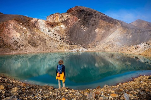 A hiker at one of the Emerald Lakes and Red Crater, Panorama, Tongariro alpine crossing, Tongariro
