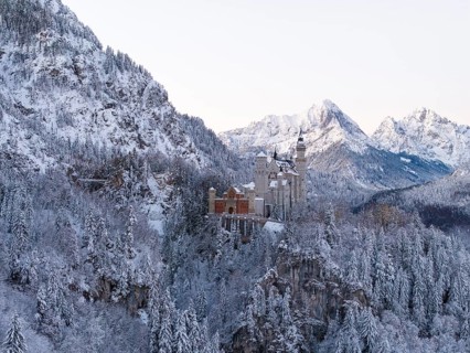 Neuschwanstein Castle rises in a snow-covered mountain landscape with romantic flair, Schwangau
