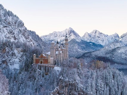 Neuschwanstein Castle rises majestically in a snowy alpine landscape, Schwangau near Füssen,