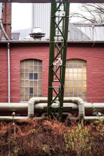 District heating pipeline in front of old industrial buildings on the banks of the Wupper,