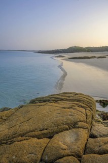 Granite rocks in the evening light and turquoise blue sea at Gurteen Beach, Roundstone, County