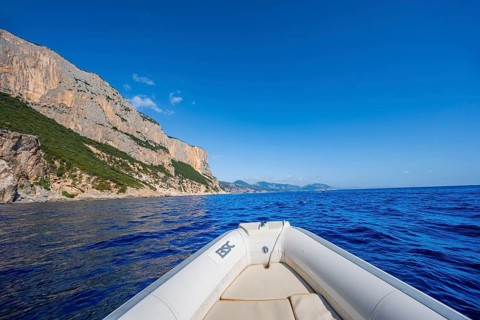 Motorboat trip along the picturesque rocky coast, cliffs and blue sea, Golfo di Orosei, Baunei,