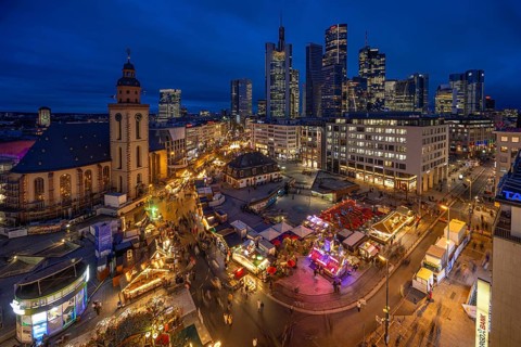 At Hauptwache, in the evening, the stalls of the Frankfurt Christmas Market and behind them the